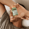Man smiling while holding Fatty15's C15 supplement in bed.