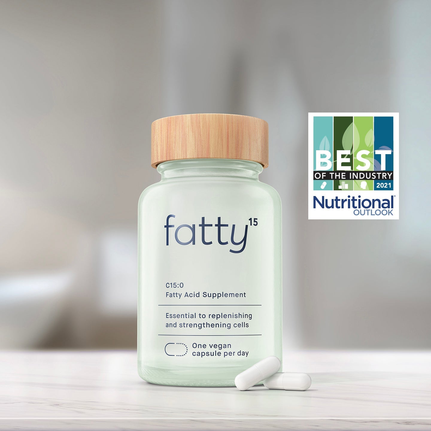 Fatty15's C15 supplement bottle on a table with a background badge.