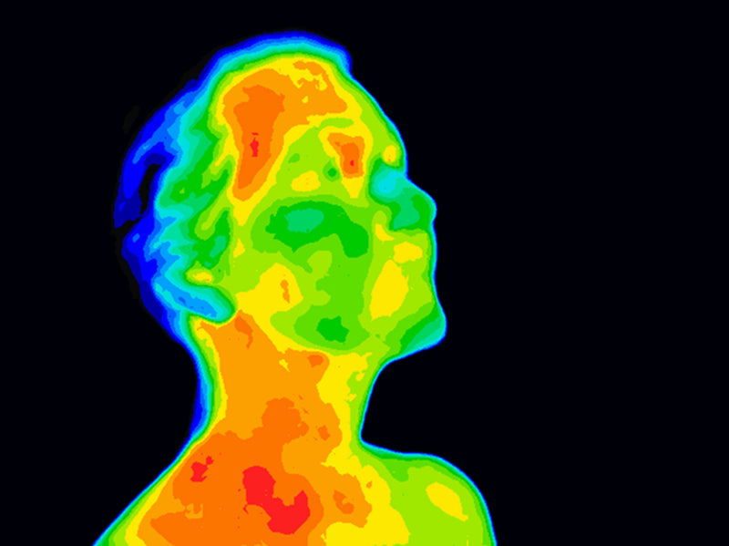 Thermal image of human head and neck displaying heat distribution.