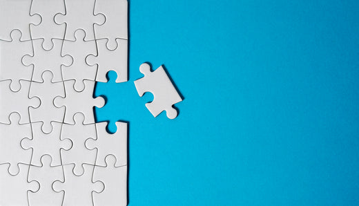 White puzzle piece missing on a blue background.