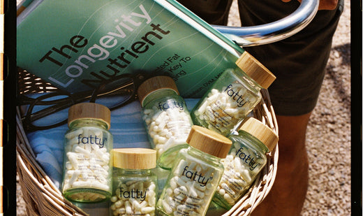 Basket with Fatty15's C15 supplement bottles and a book titled The Longevity Nutrient.