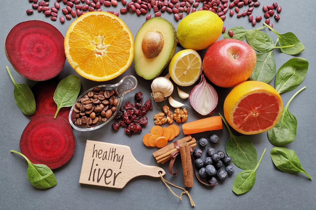 Assortment of healthy foods for liver health with fruits, vegetables, nuts, and spices.