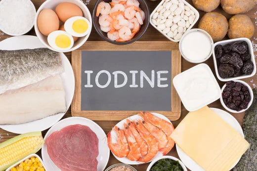 Iodine-rich foods including seafood, eggs, and vegetables surrounding a chalkboard.