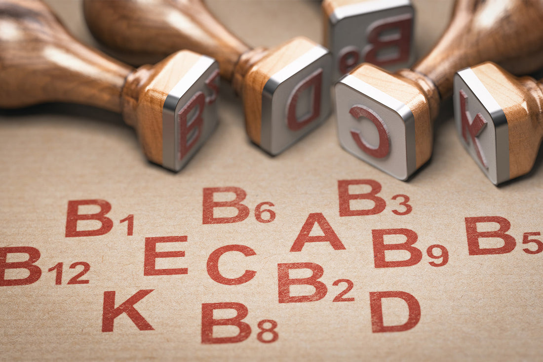 Rubber stamps with red vitamin letters on brown paper background.
