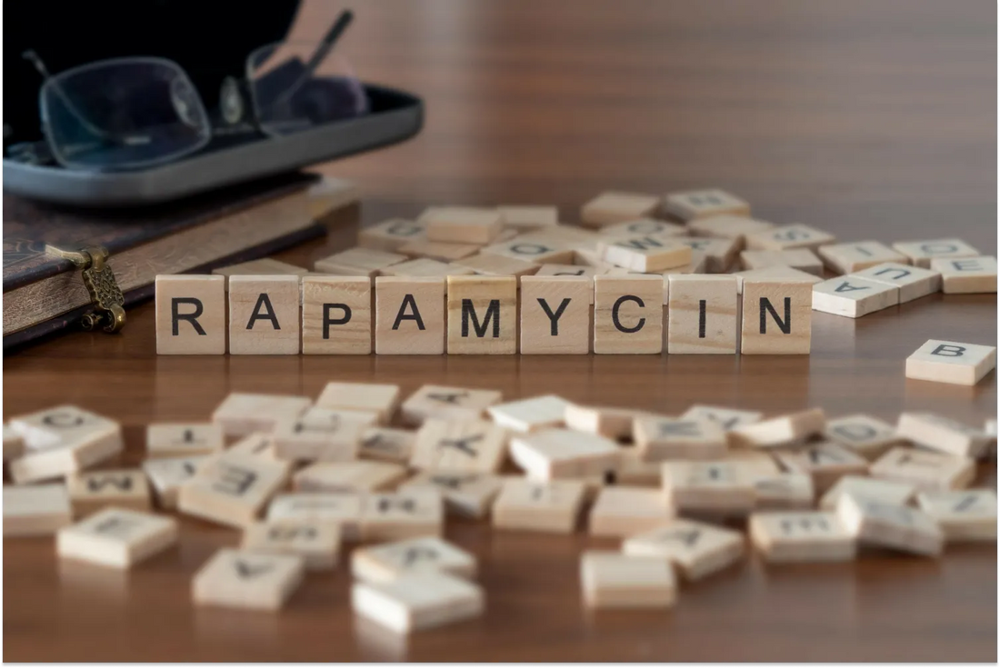 Rapamycin spelled with wooden tiles on table.