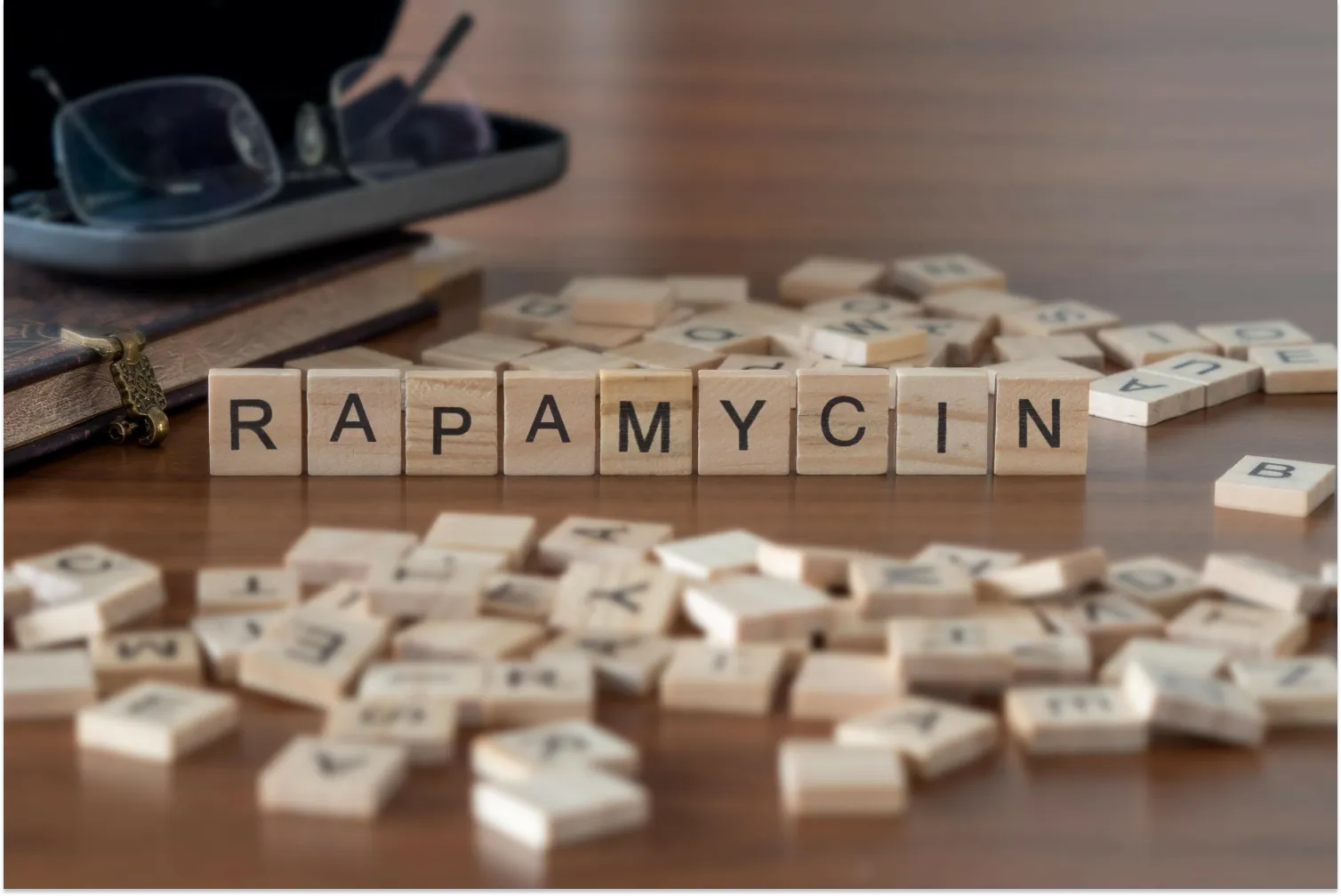 Rapamycin spelled with wooden tiles on table.