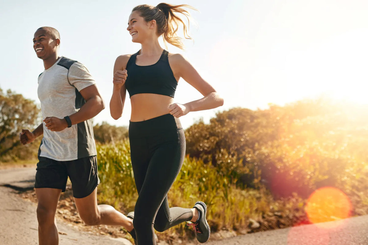 Couple jogging outdoors under the sun.