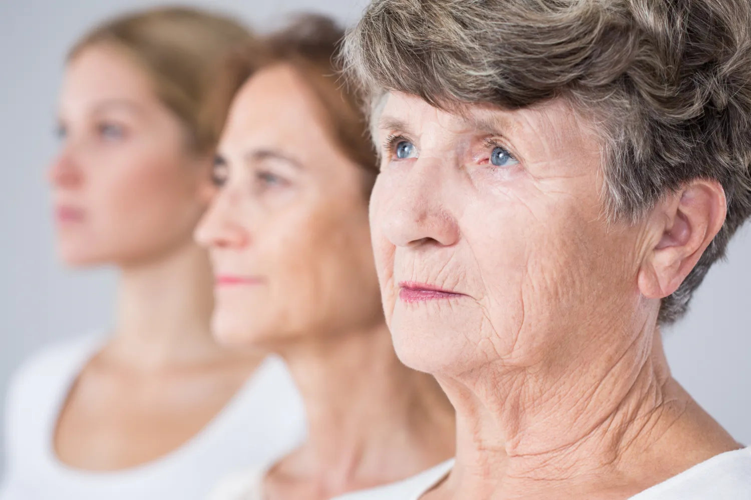 Three women aligned, symbolizing stages of aging.