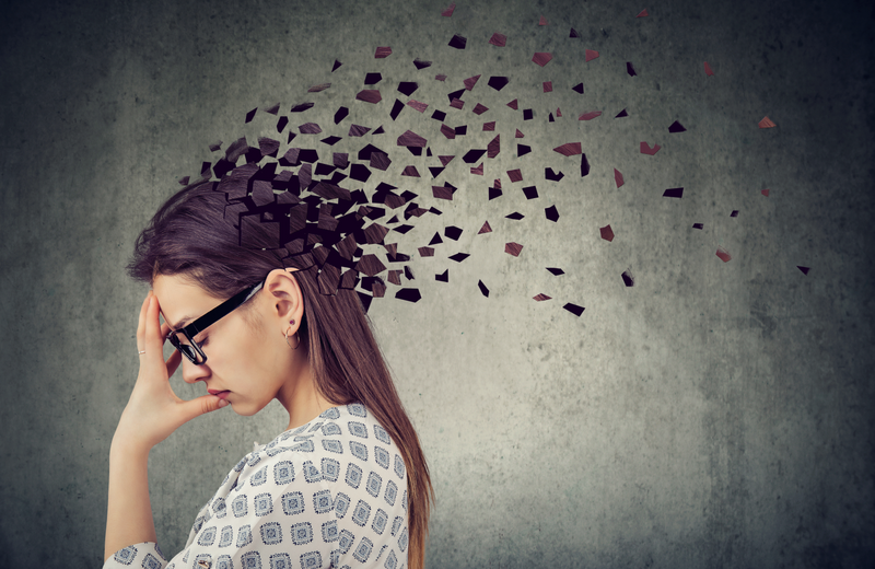 Concept of memory loss with a woman and fragmented mind.