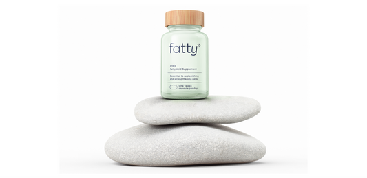 Fatty15's C15 supplement on stacked stones, natural background.