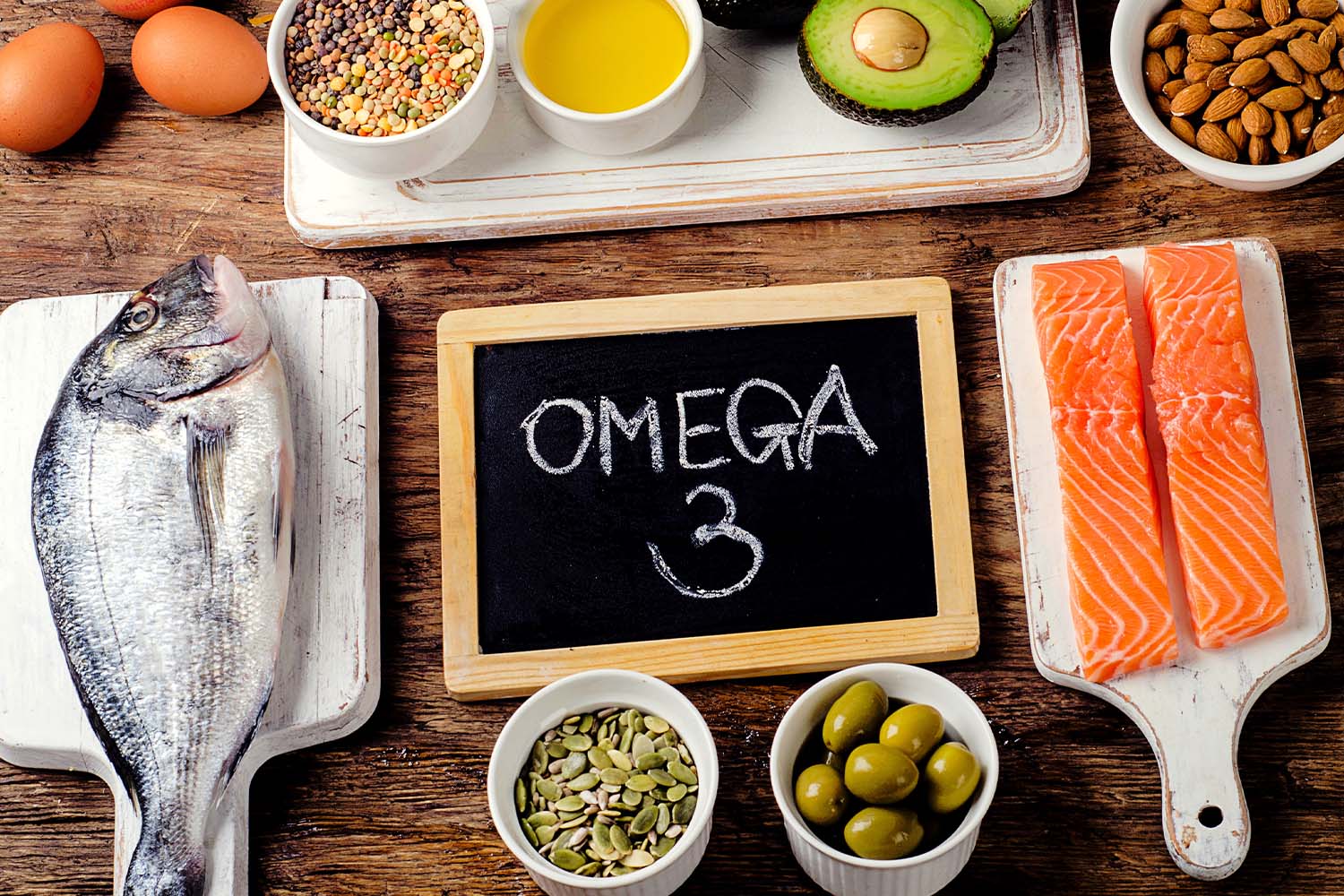 Various omega-3-rich foods on wooden table.