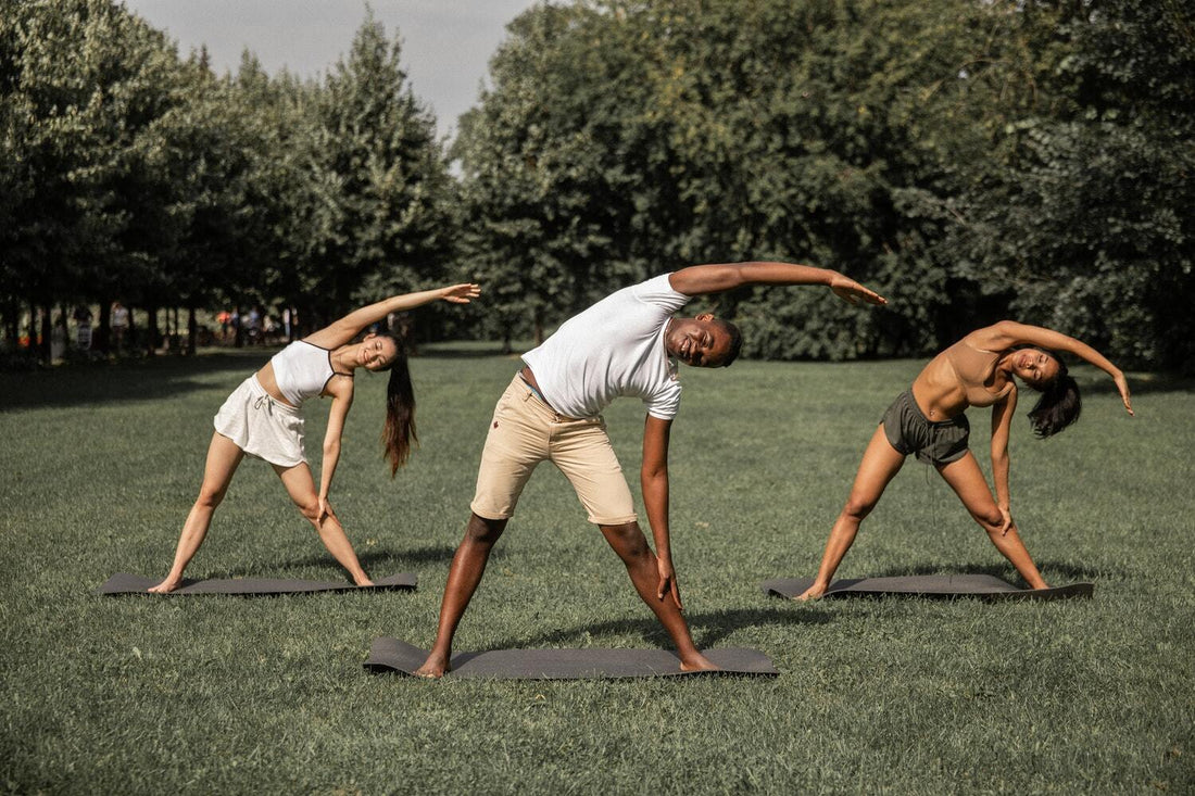 Group exercising outdoors in a park.