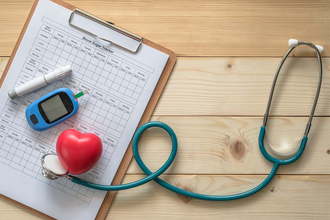 Blood sugar tracker with glucometer and stethoscope on wooden table.