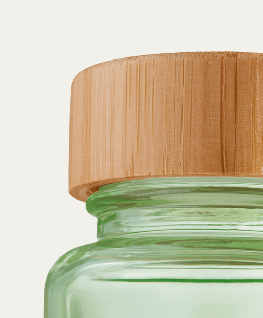 Glass bottle with bamboo lid, showing eco-friendly packaging design.