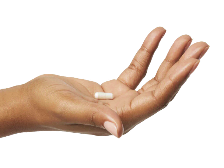 Outstretched hand holding pill