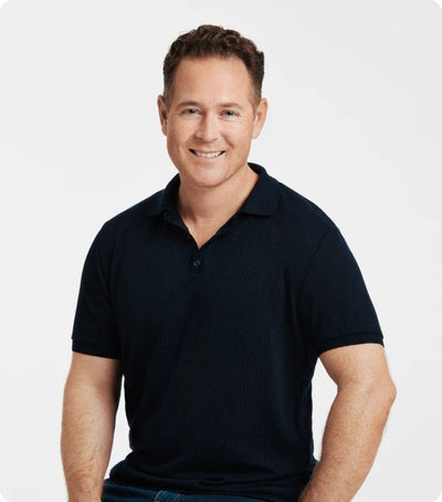 Eric Venn-Watson in black polo shirt smiling.